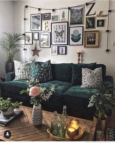 a living room filled with furniture and lots of pictures on the wall above it's coffee table