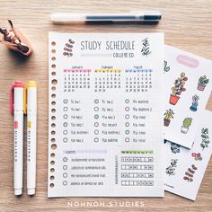 a desk with some pens and notebooks on it