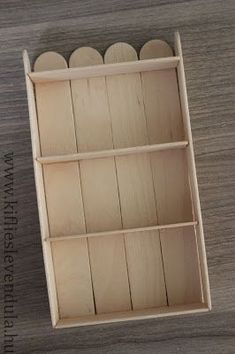 an empty wooden box on a table with several pieces of wood sticking out of it