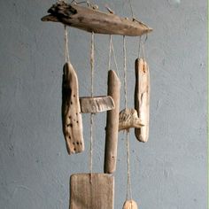 an old wooden wind chime hanging from a rope with wood slices attached to it