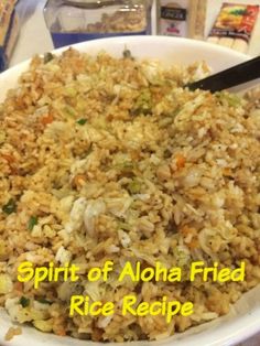 a white bowl filled with rice and veggies next to some other food items