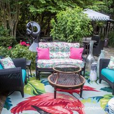 an outdoor living area with colorful furniture and plants