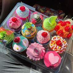 there are many cupcakes in the plastic tray