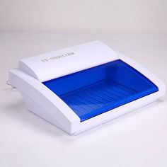 a white and blue object on a white surface with the lid open to show it's contents