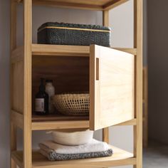 a wooden shelf with towels and other items on it