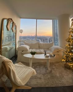 a living room filled with furniture and a christmas tree in front of a large window