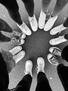 a group of people standing in a circle with their feet on each other's ankles