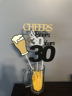 there is a glass with some food in it and a sign that says cheers and beers to 30 years ago