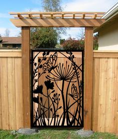 an iron gate in the shape of a flower garden with flowers and leaves on it