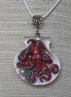 an octopus necklace is hanging from a chain