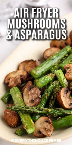 a white plate topped with mushrooms and asparagus