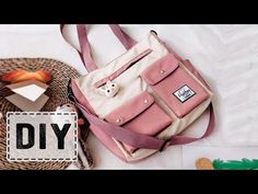 a pink and white bag sitting on top of a bed next to a straw hat