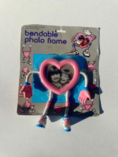 a pink and blue heart shaped photo frame