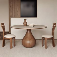 a wooden table with two chairs and a television on the wall in the back ground