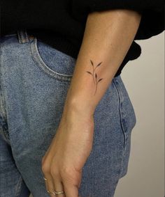 a woman with a small tattoo on her arm