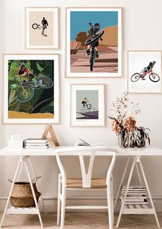 a white table topped with pictures and a vase filled with flowers next to a desk