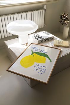 a table topped with books and a painting on top of it