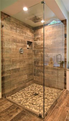 a walk in shower sitting inside of a bathroom