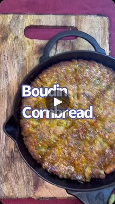 a pan filled with food sitting on top of a wooden cutting board