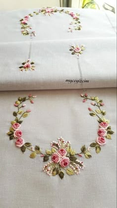 two white sheets with pink flowers on them