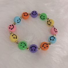 a bracelet with different colored smiley faces on it