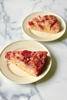 two slices of fresh strawberry rhubarb cake on plates