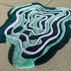 a rug that is on the ground in the middle of the street with lines painted on it