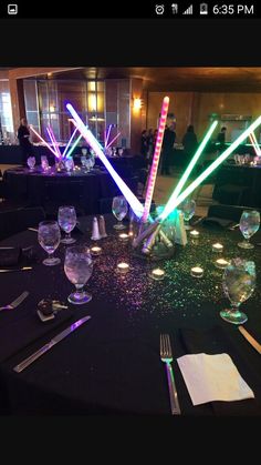 the table is set up for a party with colorful lights