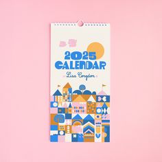 a calendar is hanging on a pink wall