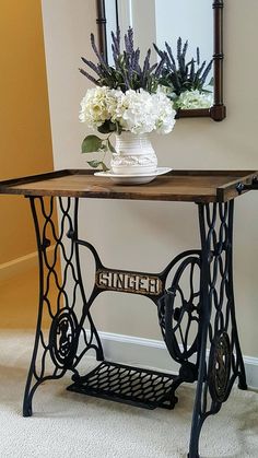 an old sewing machine table with flowers on top