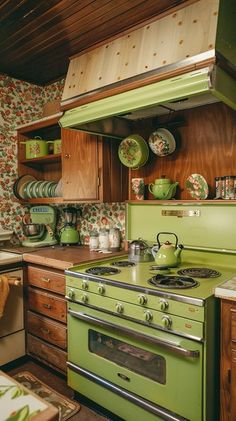 a green stove top oven sitting inside of a kitchen next to a wooden countertop