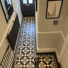 a black and white tiled floor in a hallway