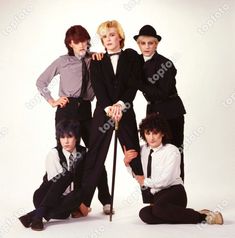 four men in suits and ties posing for a photo together with one holding a cane