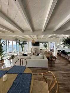 a living room filled with furniture and lots of windows