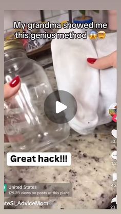 someone is holding two large glass jars with their hands