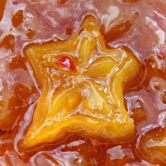 a yellow star shaped object sitting on top of liquid