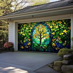 a stained glass garage door with a tree in the center and flowers on the side