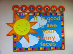 a bulletin board with the words welcome and a smiling sun