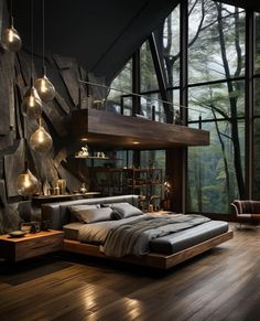 a bedroom with wood flooring and large windows overlooking the forest area is lit up by hanging lights