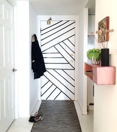 an entry way with a coat rack and shoes