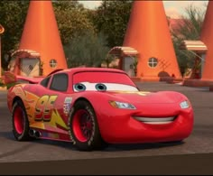 the character cars from disney pixama are in front of orange cones