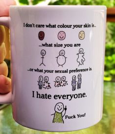 a person holding a coffee mug with some stickers on it's side that says, i hate everyone