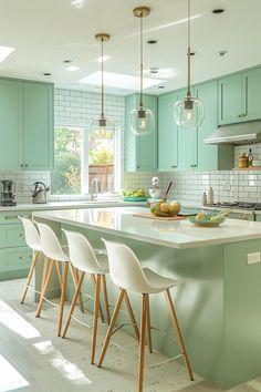 a kitchen with mint green cabinets and white counter tops, four chairs at the island