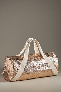 Polyester Removable, adjustable crossbody strap One inner zip pocket Two inner slip pockets Zipper styling Imported | Crinkle Metallic Duffel Bag by Anthropologie in Gold, Women's, Polyester Duffle Bags, 50 Fashion, Duffel Bag, Crossbody Strap, Women's Accessories, Duffle Bag, Zip Pockets, Bag Accessories, Anthropologie