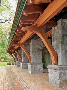 an outdoor covered walkway with stone pillars and columns