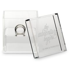 a clear acrylic ring holder with the words, the adventure begins