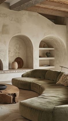 a living room filled with furniture and a fire place next to a wall mounted oven