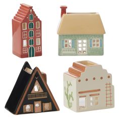 four ceramic houses are shown in three different colors