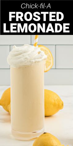 a lemonade smoothie with whipped cream on top and some lemons around it