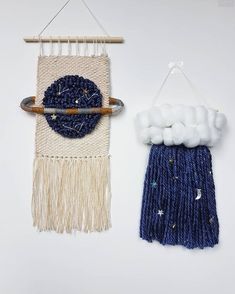 two wall hangings made out of yarn and cotton balls, one with a blue circle on it